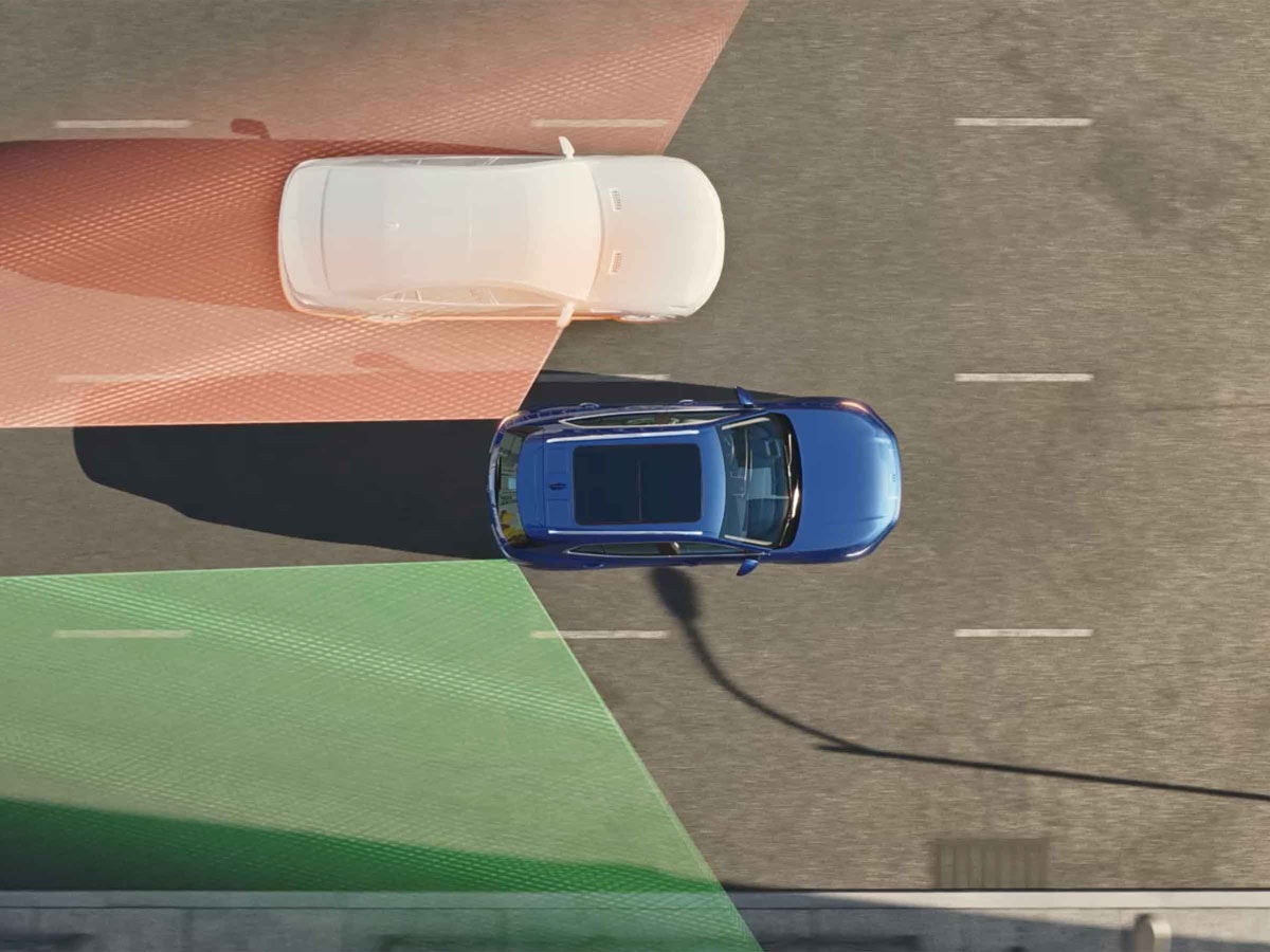 Overhead view of a blue car passing a white car, showing radar fields in front and behind.